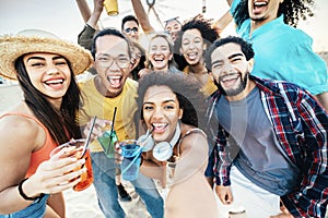 Multi-ethnic group of friends making beach party toasting cocktail glasses together - Guys and girls hanging out