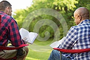 Multi-Ethnic group of friends talking and having a bible study.