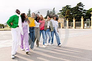 Multi ethnic group of joyful beautiful women having fun together outdoors.