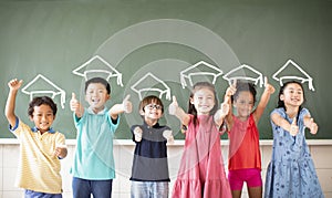Multiethnic group of school children standing in classroom photo