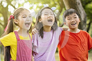 Multiethnic group of school kids laughing and embracing