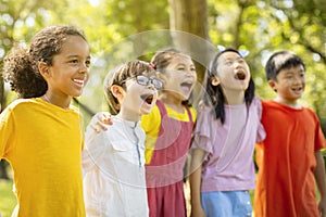 Multiethnic group of school kids laughing and embracing