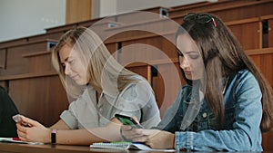 Multi Ethnic Group of Students Using Smartphones During the Lecture. Young People Using Social Media while Studying in