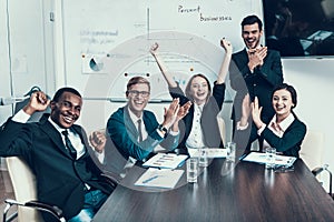 Multi ethnic group of successful business people rejoice at success in conference hall.