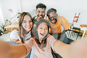 Multi ethnic guys and girls taking selfie pic indoors with smart mobile phone device