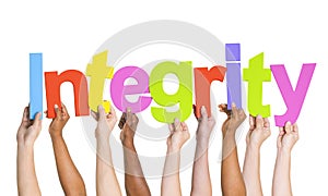 Multi-Ethnic Hands Holding The Word Integrity photo