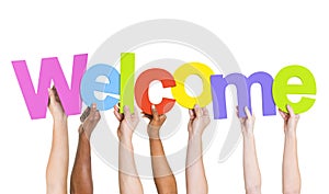 Multi-Ethnic Hands Holding The Word Welcome photo