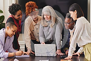 Multi ethnic mixed age range women in creative business meeting photo