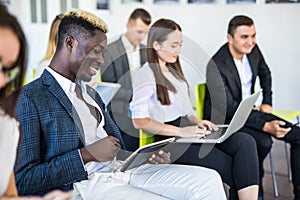 Multi-ethnic office people group using gadgets at team meeting, serious executives working on mobile phones during corporate