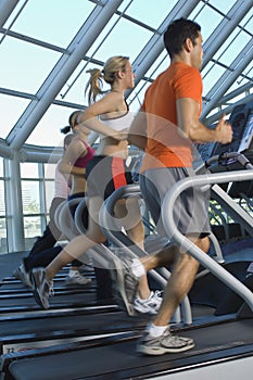 Multi Ethnic People Running On Treadmill
