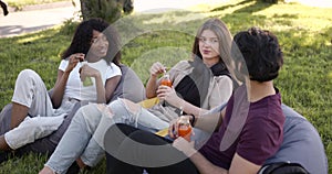 Multi ethnic students having lunch at park