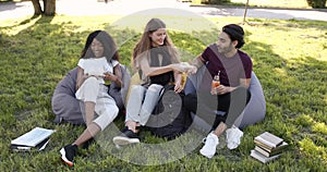 Multi ethnic students having lunch at park