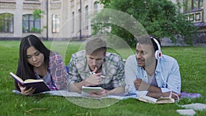 Multi-ethnic team relaxing, enjoying wonderful pastime on campus, togetherness