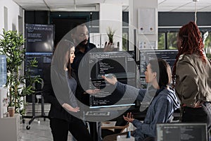 Multi ethnic web developers writing script while talking