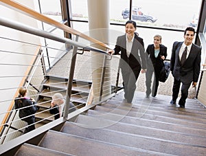 Multi-ethnic workers ascending office stairs photo