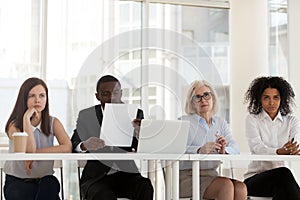 Multi-ethnic workers of recruiting agency interviewing applicant