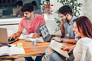 Multi ethnic young students preparing for exams in home interior