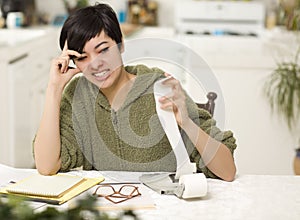 Multi-ethnic Young Woman Agonizing Over Financial Calculations