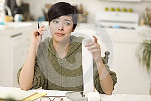 Multi-ethnic Young Woman Agonizing Over Financial Calculations photo