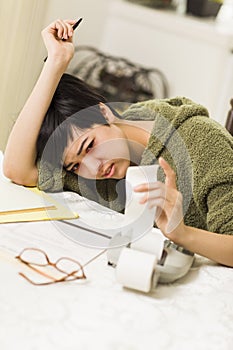 Multi-ethnic Young Woman Agonizing Over Financial Calculations photo