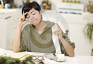 Multi-ethnic Young Woman Agonizing Over Financial Calculations photo