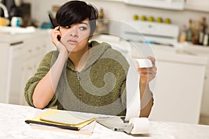 Multi-ethnic Young Woman Agonizing Over Financials photo