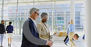 Multi ethnics business people discussing over digital tablet in the office lobby 4k