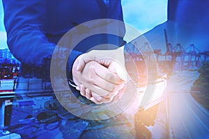 Multi exposure of Businesspeople shaking hands of business partner as commitment regarding shipping freight and industry logistics