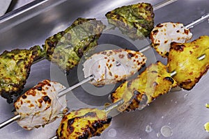 multi flavored marinated tandoori chicken tikka skewer, includes malai, hariyali and saffron kebab