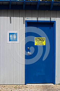 A multi-gender bathroom with a do not leave children unattended warning