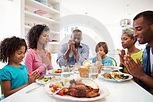 Multi Generation African American Family Praying At Home