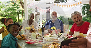 Multi-generation African American family spending time in garden together