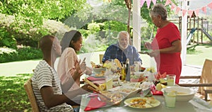 Multi-generation African American family spending time in garden together