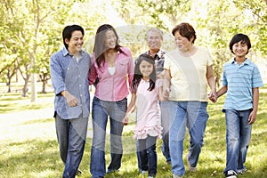 Multi-generation Asian family walking in park