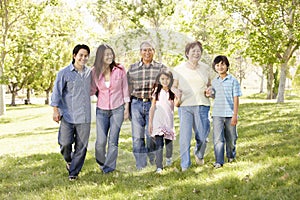 Multi-generation Asian family walking in park