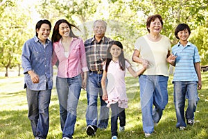 Multi-generation Asian family walking in park