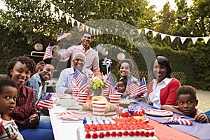 Multi generation black family having a 4th July garden party