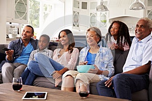 Multi generation black family watching movie on TV together