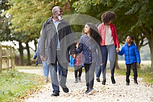 Multi Generation Family On Autumn Walk In Countryside Together