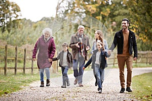 Multi Generation Family On Autumn Walk In Countryside Together