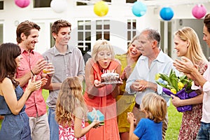 Multi Generation Family Celebrating Birthday In Garden