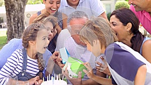 Multi Generation Family Celebrating Birthday In Garden