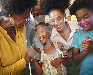 Multi-Generation Family Celebrating Granddaughter's Birthday At Home