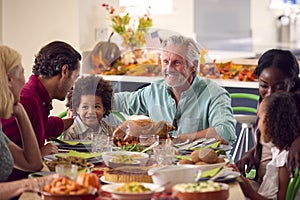 Multi-Generation Family Celebrating Thanksgiving At Home Eating Meal Together