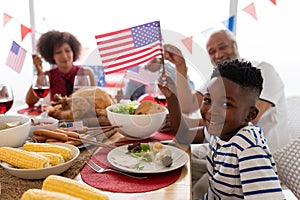 Multi-generation family celebrating US Independence day on a dining table