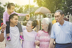 Multi generation family chatting in the park