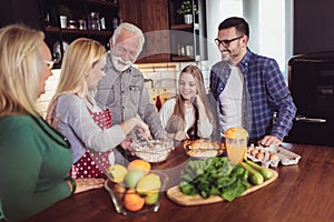 Multi Generation Family Cooking Meal At Home