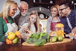 Multi Generation Family Cooking Meal At Home