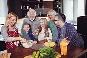 Multi Generation Family Cooking Meal At Home