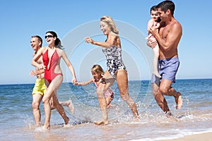 Multi Generation Family Enjoying Beach Holiday